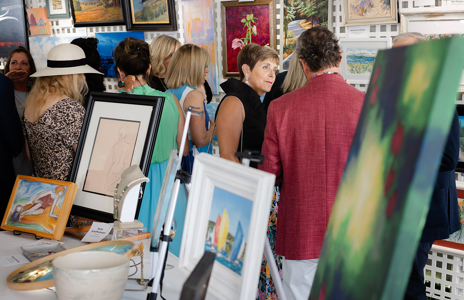 Guests enjoying the Dart for Art Gallery, which included 200+ original works of art donated by local and national artists. 